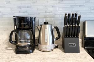une cafetière et un mixeur sur un comptoir dans l'établissement Central & Cozy 2BR Townhome with Free Parking, WiFi, Full Kitchen, Laundry, Steps to Strip Plaza & 5 Min Drive to Innisfil Beach Park! Perfect for Work Trips, Family Travel & Couples!, à Innisfil