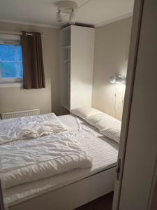a bedroom with a white bed and a window at Gula Byn 410 in Sälen +11 photos