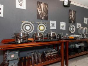 a table with pots and pans on top of it at Woodpecker's Guest House in Hazyview