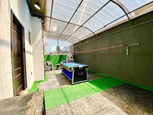 a room with a ping pong table in a building at House 8 in Lekki