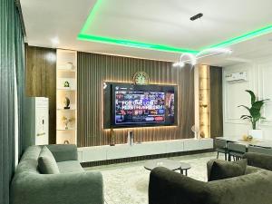 a living room with a television on a wall at House 8 in Lekki