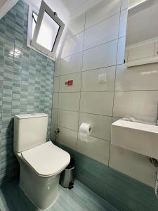 a bathroom with a toilet and a sink at ESTIA Apollon in Drama