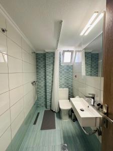 a bathroom with a sink and a toilet and a mirror at ESTIA Apollon in Drama