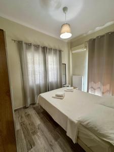 a bedroom with a large bed with white sheets at ESTIA Apollon in Drama +3 photos