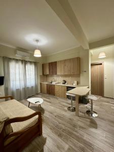 a room with a bed and a table and a kitchen at ESTIA Apollon in Drama