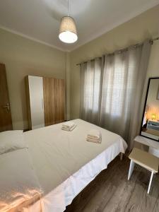 a bedroom with a bed with two towels on it at ESTIA Apollon in Drama +5 photos