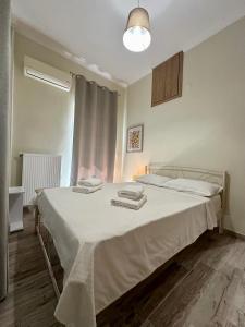 a bedroom with a bed with two towels on it at ESTIA Apollon in Drama