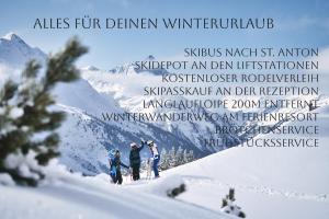 a group of three skiers on a snowy mountain at ArlBerglife Ferienresort in Pettneu am Arlberg