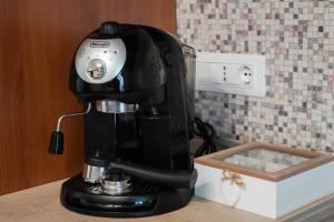 a black coffee maker on a counter next to a box at Calabria is Home in Crotone