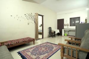 a living room with a couch and a mirror at Dean Dale Cottages in Thekkady