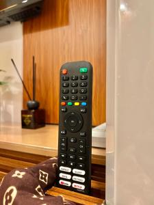 un mando a distancia sentado sobre una silla en Transient Room Near SM Lipa and LIMA PARK, en Inosloban