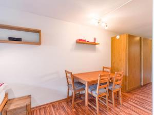 a dining room with a wooden table and chairs at Alpine Studio for 4 in Nature Parc balcony&Parking in Horboden