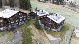 an aerial view of a large house on a hill at Alpine Studio for 4 in Nature Parc balcony&Parking in Horboden