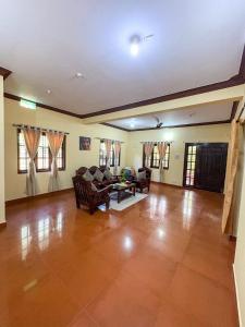 a living room with a couch and a table at KOORGI RETREAT- Coorg in Napoklu
