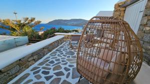 a bird cage sitting on the side of a building at Villa Spika with seaview and shared pool in Kalo Livadi