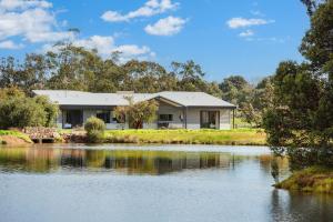 a house next to a body of water at HME Collection Sunset Dreaming in Wilyabrup
