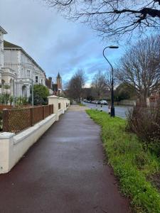 a sidewalk in a city with houses and a street light at Osborne Aparthotel in Eastbourne