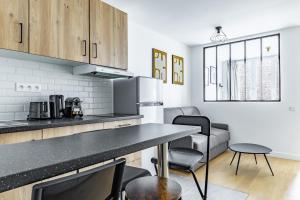 a kitchen with a black counter top in a room at Comfortable Apartment , Porte-Dorée District, Paris in Paris