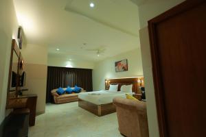 a hotel room with a bed and a couch at HOTEL SVM GRAND RAMANTHAPUR in Hyderabad
