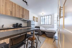 a kitchen with a counter and a living room at Comfortable Apartment , Porte-Dorée District, Paris in Paris