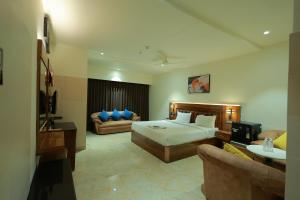 a large hotel room with a bed and a couch at HOTEL SVM GRAND RAMANTHAPUR in Hyderabad +23 photos