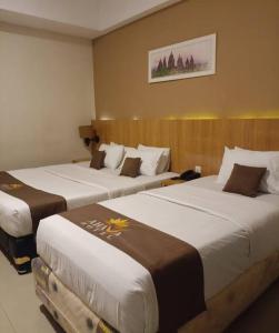 Ένα ή περισσότερα κρεβάτια σε δωμάτιο στο Grand Q Hotel Gorontalo