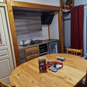 a wooden table in a small kitchen with a tableablish at Chalet Jonquille 1 in Plombières-les-Bains +5 photos
