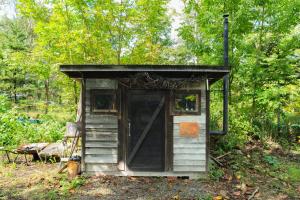 a small out house with a door in the woods at Playhouse Conifer - Vacation STAY 42761v in Mikage