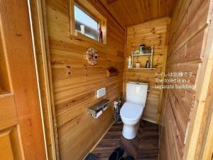 a bathroom with a toilet in a wooden cabin at Playhouse Conifer - Vacation STAY 42761v in Mikage