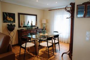 a dining room with a glass table and chairs at Ca Margarita in Benegida