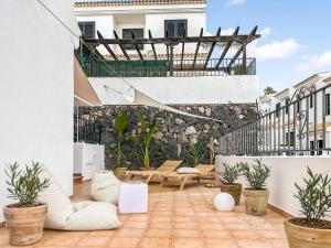 an outdoor patio with furniture and plants on a building at 3 BDR Detached house in Chayofa in Chayofa
