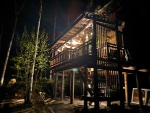 a tree house in the woods at night at Playhouse Conifer - Vacation STAY 35448v in Mikage