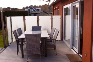 a patio with a table and chairs on a deck at uterste-coogh 102 in Den Burg
