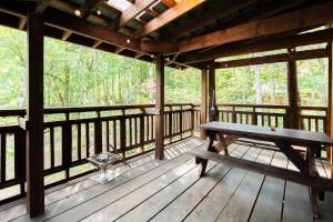 a wooden porch with a bench on a deck at Playhouse Conifer - Vacation STAY 35448v in Mikage