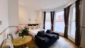 a hotel room with a bed and a table and chairs at Osborne Aparthotel in Eastbourne