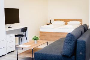 a living room with a couch and a bed at Urban76 Apartments in Târgu-Mureş