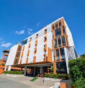 a white building with a lot of windows at WE Terminal Hotel in Chiang Mai