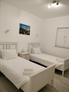 Postel nebo postele na pokoji v ubytování Maria's Village