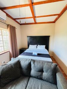 a bedroom with a large bed in a room at DeRockview Lodge in Johannesburg
