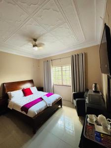 a bedroom with a large bed and a couch at DeRockview Lodge in Johannesburg +42 photos