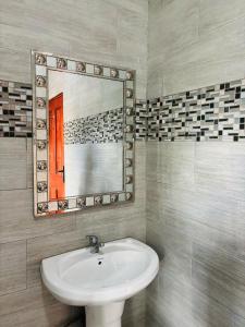 a bathroom with a sink and a mirror at DeRockview Lodge in Johannesburg