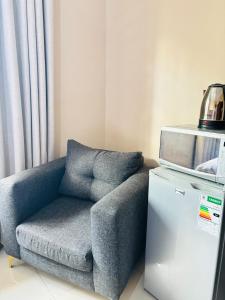 a blue chair sitting next to a small refrigerator at DeRockview Lodge in Johannesburg