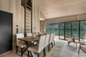 a dining room with a table and chairs and a large window at Tenden Panorama in Stryn
