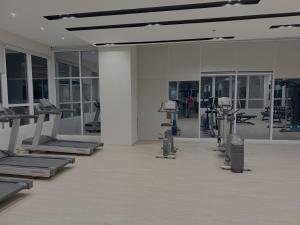 a gym with a row of treadms and machines at Sitari Condo Bacolod in Bacolod