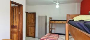 a bedroom with two bunk beds and a door at Residencial Jmulguero in Guaratuba