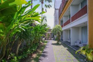 a walkway through the courtyard of a building at Kamini Legian Hotel in Legian