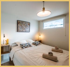 a bedroom with a large bed with towels on it at Chez Anaïs I T1 I Sauverny in Sauverny