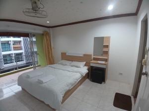 Ένα ή περισσότερα κρεβάτια σε δωμάτιο στο Didim Guest House Patong