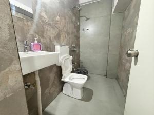 a bathroom with a toilet and a sink at hotel elevate suites in Nagpur