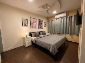 a bedroom with a large bed and a window at hotel elevate suites in Nagpur +9 photos